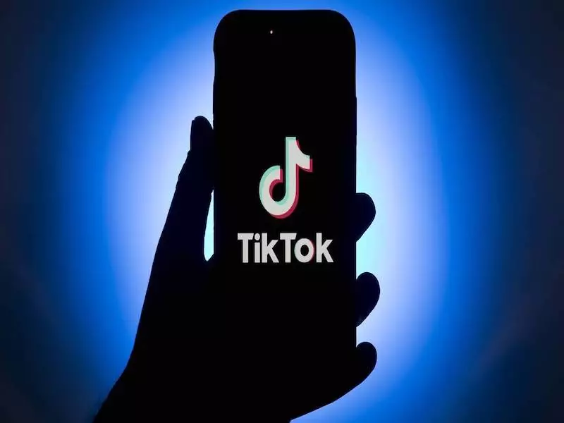 holding smartphone with tiktok app