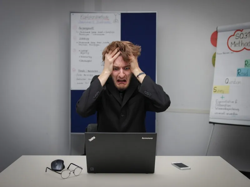 man frustrated at computer