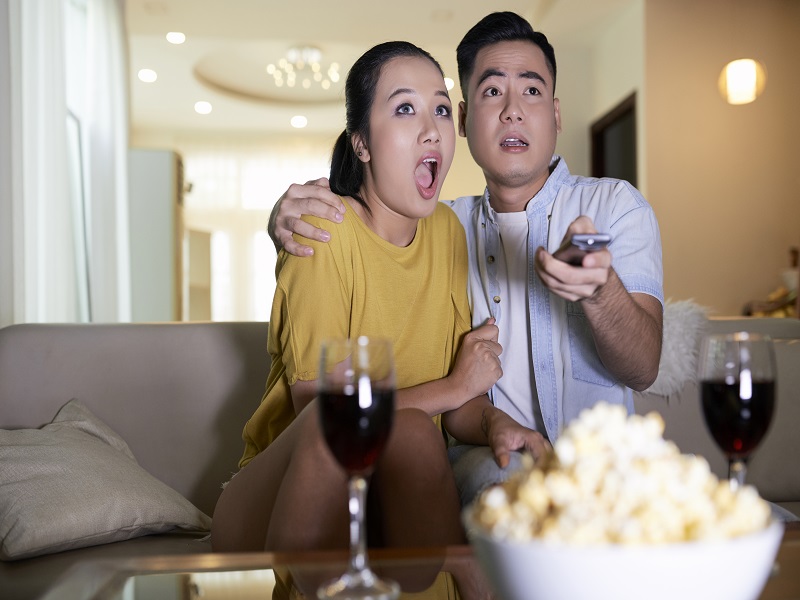 couple watching scary movie at home